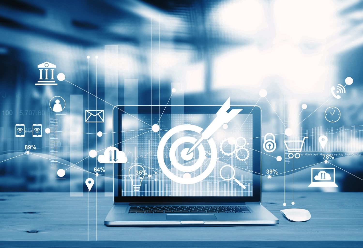 A computer sitting on a desk with multiple symbols surrounding it representing Market Competition in the Industrial and Manufacturing Industry.